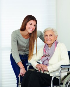 Young woman and senior citizen in wheelchair